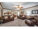 Spacious living room with leather sofas, neutral carpeting, and ample seating at 5223 Willow Ridge Dr, Woodstock, GA 30188