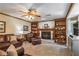Cozy living room featuring a fireplace, built-in bookshelves, and comfortable leather furniture at 5223 Willow Ridge Dr, Woodstock, GA 30188