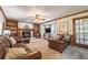 Comfortable living room with built-in bookshelves surrounding a fireplace, complemented by plush leather furniture at 5223 Willow Ridge Dr, Woodstock, GA 30188