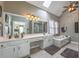 Elegant main bathroom with double vanity, soaking tub, skylight, and walk-in shower at 5223 Willow Ridge Dr, Woodstock, GA 30188