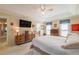 Comfortable main bedroom with tv, tray ceiling, and ample natural light at 5223 Willow Ridge Dr, Woodstock, GA 30188