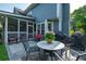 Outdoor patio with a stone floor, table, and chairs for entertaining at 5223 Willow Ridge Dr, Woodstock, GA 30188
