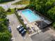 Community swimming pool featuring lap lanes, chairs, umbrellas and mature trees in a safe environment at 5223 Willow Ridge Dr, Woodstock, GA 30188