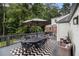 Back deck with large dining table, outdoor furniture, and wooded views at 879 Wildwood Ne Rd, Atlanta, GA 30324