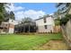 Green backyard featuring a stone foundation, wooden fence, and partial forest views at 879 Wildwood Ne Rd, Atlanta, GA 30324
