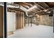 Spacious unfinished basement with stone walls, exposed ductwork, and concrete flooring at 879 Wildwood Ne Rd, Atlanta, GA 30324