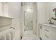 Modern bathroom featuring a glass-enclosed shower, hexagon tile floor, and white marble countertop at 879 Wildwood Ne Rd, Atlanta, GA 30324
