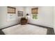 Bright bedroom featuring natural light from two windows with woven shades and a cozy chair on a plush rug at 879 Wildwood Ne Rd, Atlanta, GA 30324