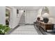 Entryway featuring a patterned rug, staircase, decorative table with lamps, and a view to the backyard at 879 Wildwood Ne Rd, Atlanta, GA 30324