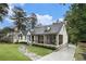 Charming home featuring a stone walkway, screened porch, and well-manicured landscaping creating an inviting curb appeal at 879 Wildwood Ne Rd, Atlanta, GA 30324