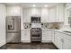Modern kitchen featuring stainless steel appliances, white cabinets, and elegant countertops perfect for cooking and entertaining at 879 Wildwood Ne Rd, Atlanta, GA 30324