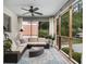 Relaxing screened porch features comfortable seating, stylish decor, and a ceiling fan for year-round enjoyment at 879 Wildwood Ne Rd, Atlanta, GA 30324