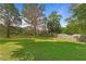 Spacious backyard with a wooden fence, a shed, and many mature trees at 121 Gosdin Rd, Palmetto, GA 30268