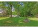Large backyard features a play area and brick fire pit at 121 Gosdin Rd, Palmetto, GA 30268