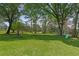 A huge backyard with a fire pit and a swing set, surrounded by lush greenery at 121 Gosdin Rd, Palmetto, GA 30268