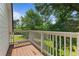 Wooden balcony with white railings overlooking the lush green yard at 121 Gosdin Rd, Palmetto, GA 30268