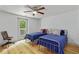 Bright bedroom with two twin beds, ceiling fan, and access to a deck at 121 Gosdin Rd, Palmetto, GA 30268