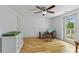 Bright bedroom with a ceiling fan, hardwood floors, and access to a private balcony at 121 Gosdin Rd, Palmetto, GA 30268