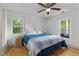 Comfortable bedroom featuring hardwood floors and two windows with natural light at 121 Gosdin Rd, Palmetto, GA 30268