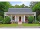 Charming home with a welcoming front porch, American flag, and lovely landscaping at 121 Gosdin Rd, Palmetto, GA 30268
