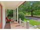 Relaxing front porch with outdoor seating, offering a tranquil view of the surrounding nature at 121 Gosdin Rd, Palmetto, GA 30268