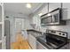 Clean kitchen with stainless steel appliances, granite counters, and bright lighting at 121 Gosdin Rd, Palmetto, GA 30268