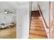 Hallway with a view of the naturally lit living room and hardwood stairs with white accents at 121 Gosdin Rd, Palmetto, GA 30268