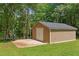 Backyard features a large storage shed with a concrete patio and a charcoal grill at 121 Gosdin Rd, Palmetto, GA 30268