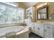 Bright bathroom features a soaking tub, vanity, and natural light at 1821 N Rock Springs Ne Rd, Atlanta, GA 30324