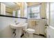 Bathroom with a pedestal sink, tiled walls, and a window at 1821 N Rock Springs Ne Rd, Atlanta, GA 30324