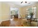 Sunlit dining room with hardwood floors, a glass table, and views to living area at 1821 N Rock Springs Ne Rd, Atlanta, GA 30324