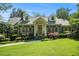 Traditional brick home featuring a lush front lawn, dormer windows, and manicured landscaping at 1821 N Rock Springs Ne Rd, Atlanta, GA 30324