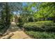Serene front yard with lush greenery and a stone pathway leading to the house at 1821 N Rock Springs Ne Rd, Atlanta, GA 30324
