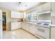 Bright kitchen with white cabinets, appliances, and tile flooring at 1821 N Rock Springs Ne Rd, Atlanta, GA 30324