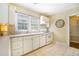 Well-lit kitchen showcasing white cabinets, ample countertop space, and tile flooring at 1821 N Rock Springs Ne Rd, Atlanta, GA 30324