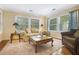 Bright living room featuring neutral-toned walls, carpeted floors, and large windows at 1821 N Rock Springs Ne Rd, Atlanta, GA 30324
