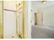 Shower featuring white tile, gold trim, and a glass door. A small part of the bedroom is in the view at 1821 N Rock Springs Ne Rd, Atlanta, GA 30324