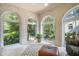 Cozy sunroom featuring large windows with views of the lush, landscaped yard at 1821 N Rock Springs Ne Rd, Atlanta, GA 30324