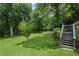 A well-manicured backyard with lush green grass and mature trees, perfect for outdoor activities at 208 Bruce Ct, Dallas, GA 30157