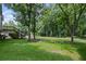 Expansive backyard features a deck and mature trees, offering a serene and private outdoor space at 208 Bruce Ct, Dallas, GA 30157