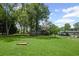 An expansive backyard with a well-kept lawn, a shed, and mature trees creating a park-like setting at 208 Bruce Ct, Dallas, GA 30157