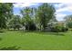 A sizable backyard featuring mature trees, a lush lawn, and landscaping creating a beautiful outdoor space at 208 Bruce Ct, Dallas, GA 30157