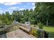 A large backyard deck with view of the woods provides private outdoor living at 208 Bruce Ct, Dallas, GA 30157