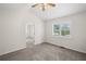 Bright bedroom featuring neutral carpet, ceiling fan, and window for natural light at 208 Bruce Ct, Dallas, GA 30157