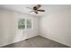 Clean bedroom with ceiling fan and bright window offering lots of natural light at 208 Bruce Ct, Dallas, GA 30157