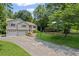 Inviting home with a neatly manicured lawn and a long driveway leading to a two-car garage at 208 Bruce Ct, Dallas, GA 30157