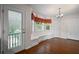 Bright eat-in kitchen with wood floors, a door to the deck, breakfast nook with bench, and plenty of natural light at 208 Bruce Ct, Dallas, GA 30157