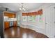 Bright eat-in kitchen with wood floors, stainless steel appliances, breakfast nook with bench, and plenty of natural light at 208 Bruce Ct, Dallas, GA 30157