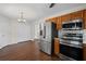 Kitchen with stainless appliances, tiled backsplash, wood floors, and white doors, providing ample storage space at 208 Bruce Ct, Dallas, GA 30157