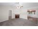 Cozy living room showcasing a stone fireplace with a ceiling fan and adjacent dining space at 208 Bruce Ct, Dallas, GA 30157